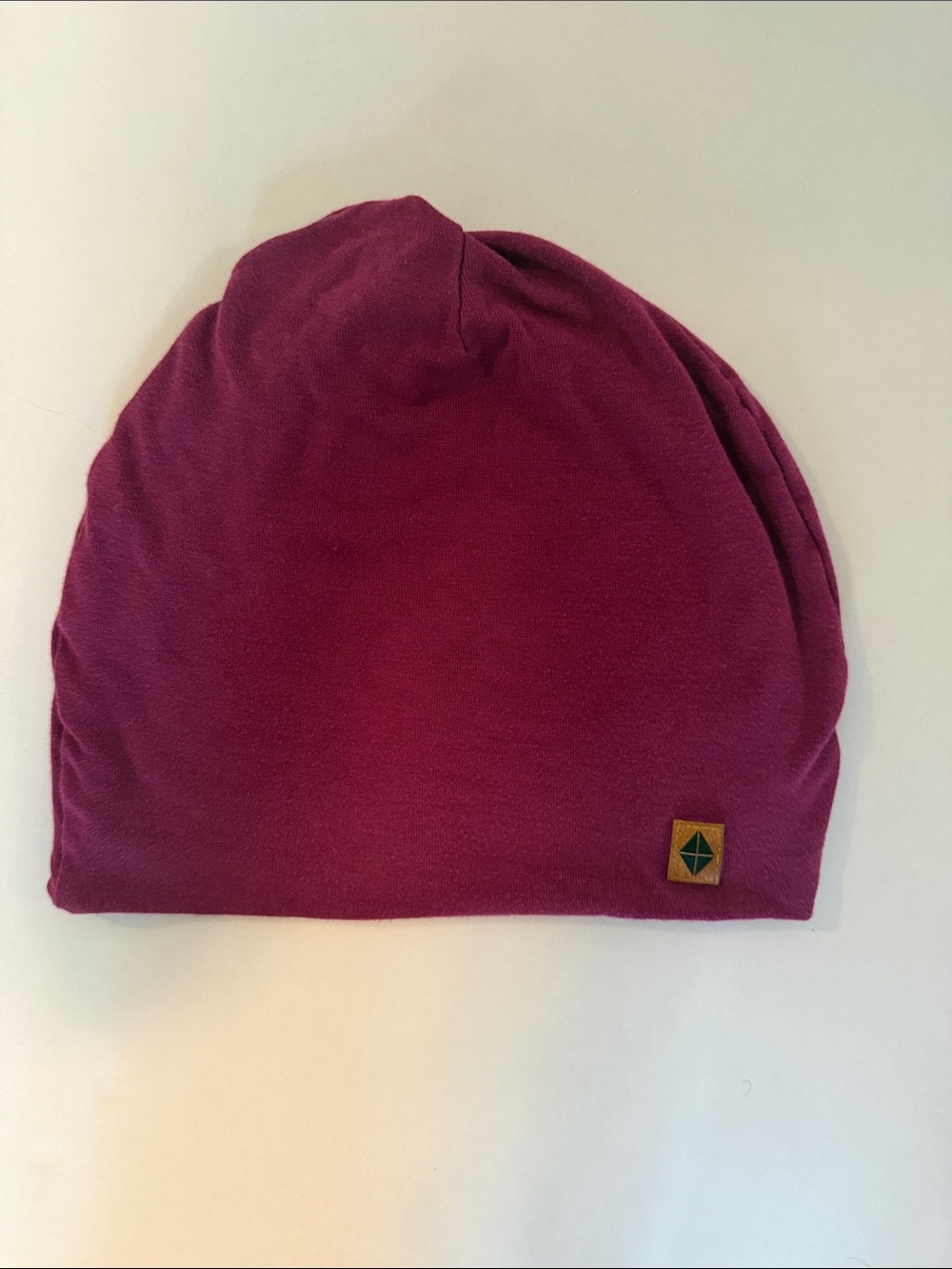 Kyte BABY Slouch Beanie in Deep Berry with Leather Logo